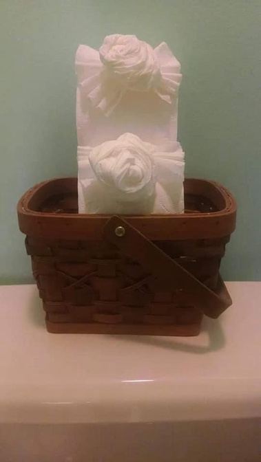 Toilet paper roses arranged in a basket