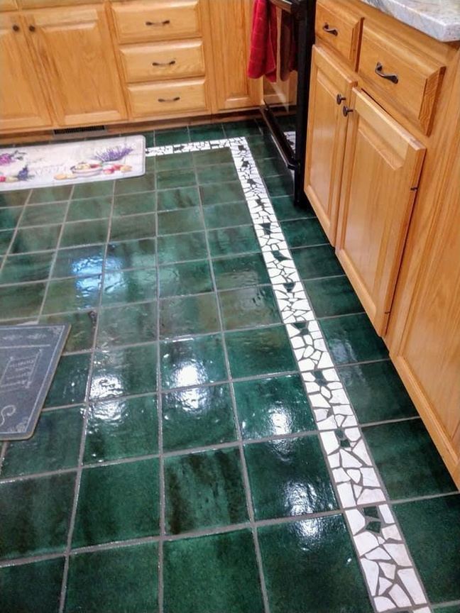 Green tile kitchen floor gleaming after cleaning
