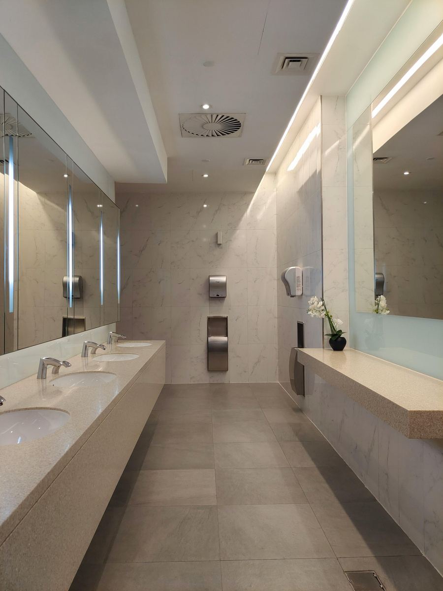 Immaculate commercial restroom with marble finishes